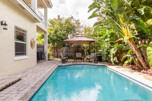 a swimming pool in the backyard of a house at Our boutique Fort Lauderdale guest house in Fort Lauderdale