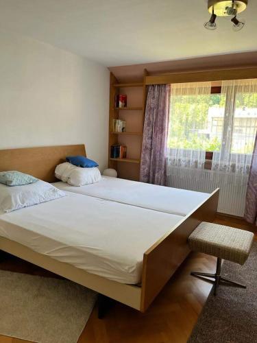 a bedroom with a large bed and a window at Felsenblick Himmelsfels in Geislingen an der Steige