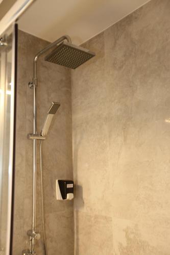 a shower with a shower head in a bathroom at Medusa Apartments in Rethymno Town