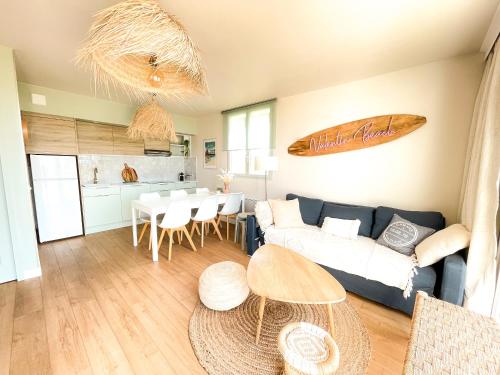 - un salon avec un canapé et une table dans l'établissement Sur la plage Valentin Beach Home - T3bis, à Batz-sur-Mer