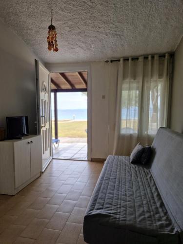 a living room with a couch and a view of the ocean at On the wave studios Spitakia sto kyma in Nikiti