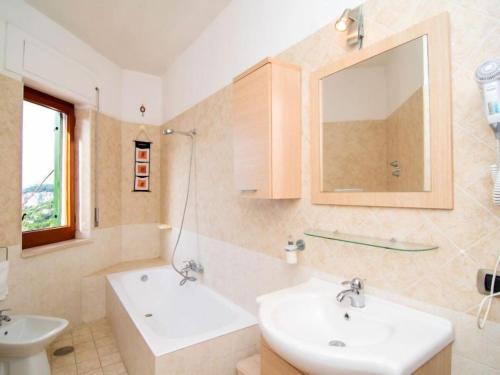 a bathroom with two sinks and a mirror at Villa Lobra in Massa Lubrense