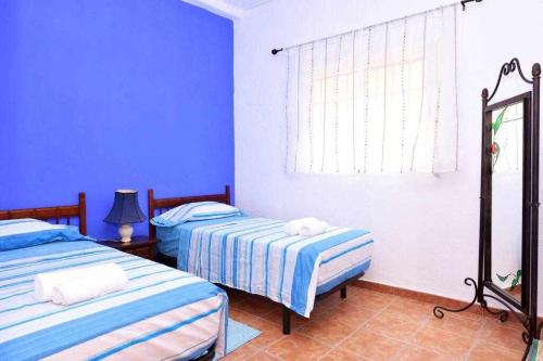 A bed or beds in a room at Cortijo Algarrobo Casa de Campo tranquila