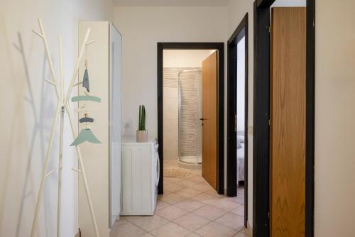 a hallway with an open door to a room at Le Case di Salvia in San Vincenzo