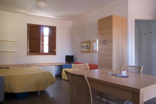a room with a table and chairs and a desk at Borgo Etrusco in Scarlino