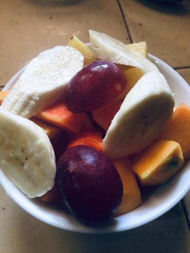 a plate of fruit and vegetables on a table at Agasthi Airport Close in Katunayake