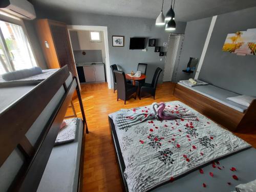 a small room with a bed and a living room at Apartment Jonoski in Ohrid