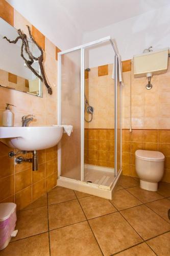 a bathroom with a shower and a sink and a toilet at Le Navi In Cielo in Imperia