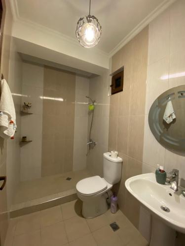 a bathroom with a toilet and a shower and a sink at Sunny Days in K'obulet'i