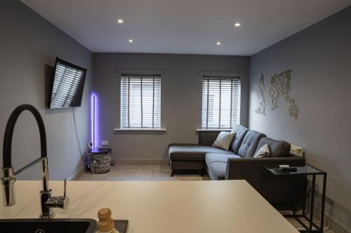a living room with a couch and a purple light at #4 Stylish City Centre Apartment with Free Private Parking, close to Hull New Theatre and Connexin Live Arena in Hull