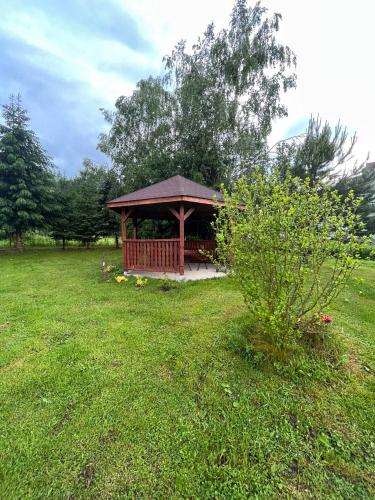 a gazebo in the middle of a grass field at Domki u Pieszczocha in Bukowiec