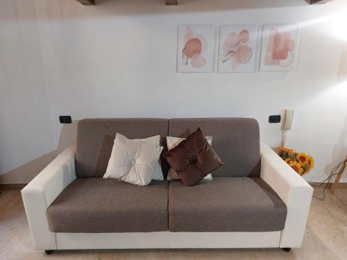 a couch with pillows on it in a living room at Suite del Conservatorio nel centro storico in Lecce