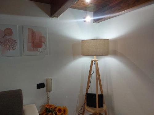 a lamp in a corner of a room at Suite del Conservatorio nel centro storico in Lecce