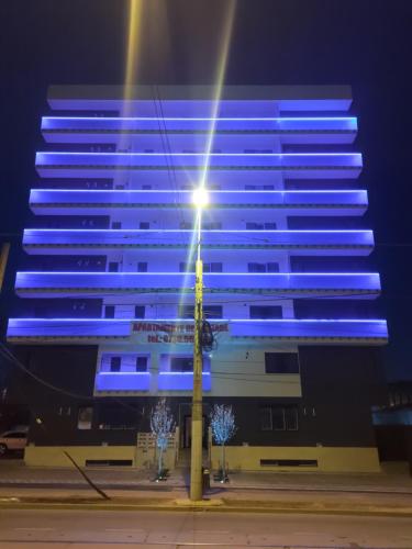 a blue building with a street light in front of it at Global Residence in Bucharest