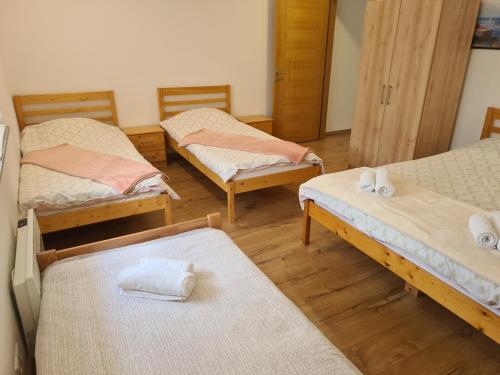 a room with four beds with towels on them at Holiday Home Faruk in Račić
