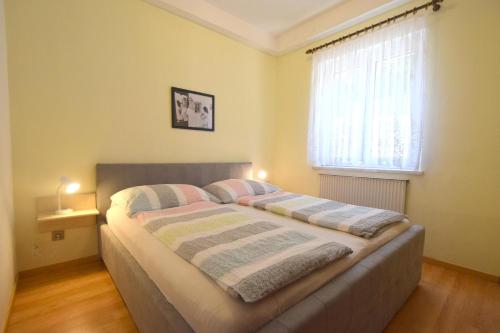 a bedroom with a bed with two pillows on it at Apartments Frane in Vantačići