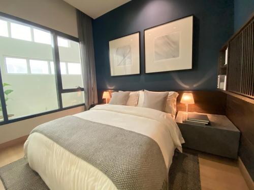 a bedroom with a large bed and two windows at Landing Park Lucentia Suite BBCC in Kuala Lumpur