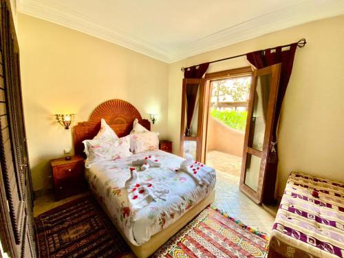 a bedroom with a large bed and a mirror at Villa Agdal in Marrakech