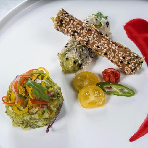 a white plate of food with sushi and vegetables at Raffles Makkah Palace in Makkah