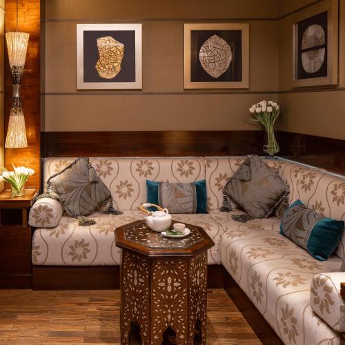 a living room with a couch and a table at Raffles Makkah Palace in Makkah
