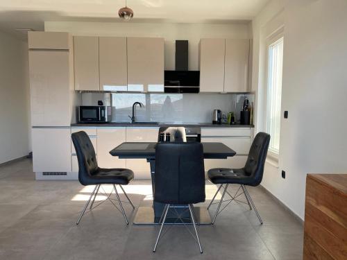 a kitchen with a table and chairs in a room at Apartment Primero in Primošten