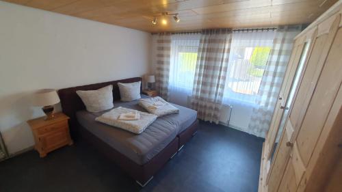 a small bedroom with a bed and a window at WinterbergerQuartier in Winterberg
