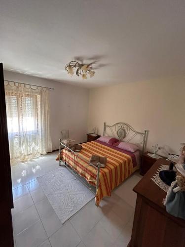 a bedroom with a bed and a ceiling fan at Casa vacanze in Berchidda