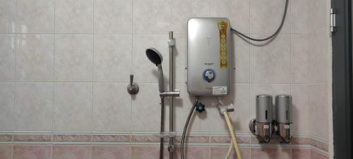 a soap dispenser on the wall of a bathroom at Grey Fantasy Homes#Sunway Water Theme Park in Ipoh