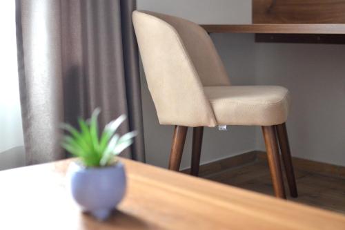 a chair sitting on top of a wooden table at ĆAKA Luxury Rooms & Restaurant in Ćuprija