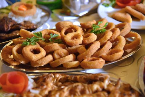 a plate of onion rings on a table at ĆAKA Luxury Rooms & Restaurant in Ćuprija