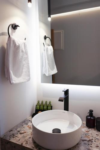 a bathroom with a large white sink on a counter at Uphill Unique Boutique Suites in Skiathos Town