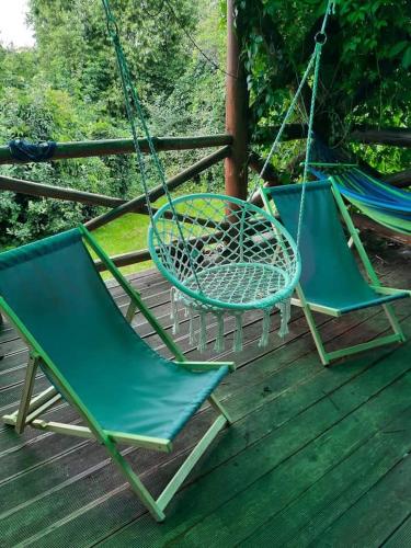 two chairs and a hammock on a deck at OAZA in Olsztyn