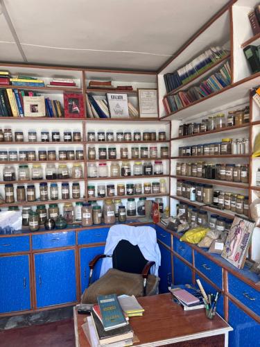 a room with a desk and shelves with books at Hotel Dancing Yak in Lete