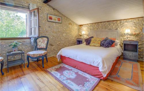 a bedroom with a bed and a stone wall at Amazing Home In Douzillac With 4 Bedrooms And Outdoor Swimming Pool in Douzillac