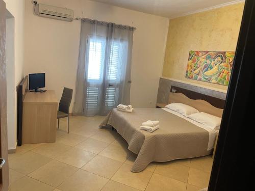 a bedroom with a bed with two towels on it at Bed and breakfast KALE ' in Porto Cesareo