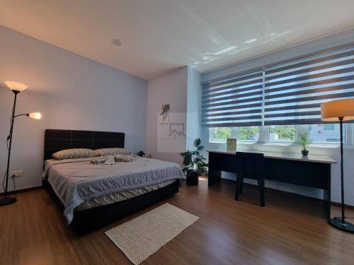 a bedroom with a bed and a desk and a window at SERENE HEIGHTS ONE BEDROOM STUDIO in Miri