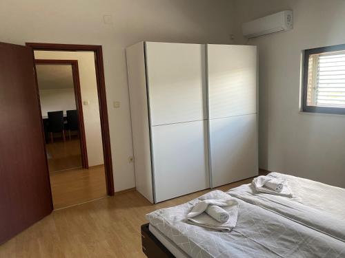 a bedroom with a bed and a large closet at Villa Una Apartments in Labin