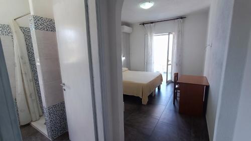 a room with a bedroom with a bed and a window at La Dea del Mare in Ischia