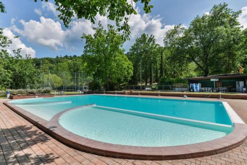 a large swimming pool with a brick patio at 38-Casa Volpin Relax e Sport in Toscana in Castel del Piano