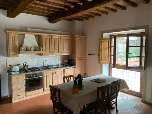 a kitchen with a table and chairs in a room at Holiday home Garetto in Chianni