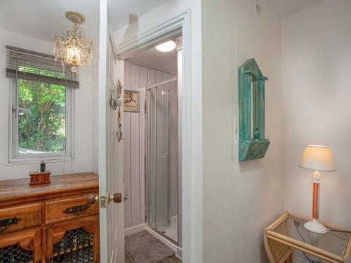 a bathroom with a walk in shower and a mirror at Teign Retreat in Teignmouth