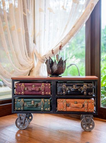 a pile of suitcases on a cart in front of a window at The Retreat at Ngorongoro in Karatu