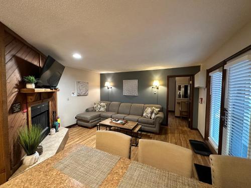 a living room with a couch and a table at Caribbean Club Resort in Wisconsin Dells