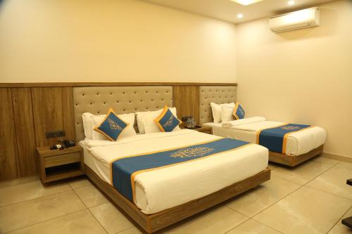 a hotel room with two beds in a room at HOTEL HOLISTON in Dwarka