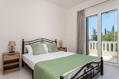 a bedroom with a bed and a large window at Emily Apartment in Zakynthos Town