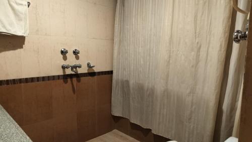 a bathroom with a shower with a shower curtain at Auspiscious Him View Hotel in McLeod Ganj