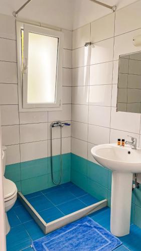 a bathroom with a shower and a sink at ELÉA Guesthouse himare in Himare