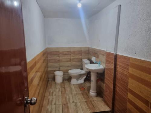 a bathroom with a toilet and a sink at Villa violeta beach resort in San Juan