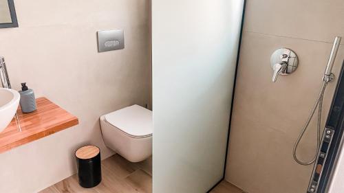 a bathroom with a toilet and a sink and a shower at ELÉA Guesthouse himare in Himare