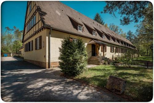 a large building with a tree in front of it at Jugendhotel Nürnberg in Nürnberg